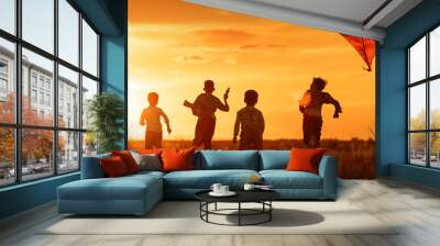 Children with a kite at sunset Wall mural