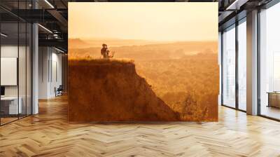 Children with tourists on a cliff at sunset Wall mural