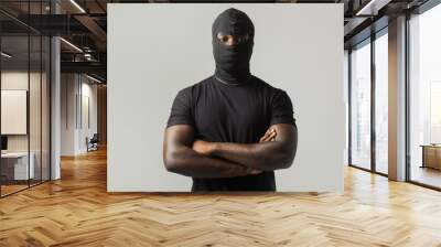 young african man in a black mask and a black t-shirt on a gray background Wall mural