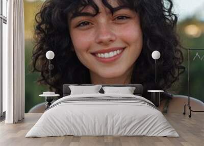 Young woman with curly hair Wall mural