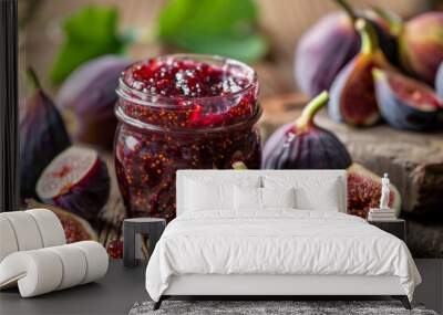 Artisanal fig jam in a clear jar surrounded by fresh figs on rustic wooden table, depicting homemade preserves Wall mural