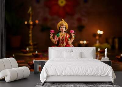 Beautiful clay idol of hindu goddess lakshmi sitting on lotus flower surrounded by diya lamps for diwali celebration Wall mural