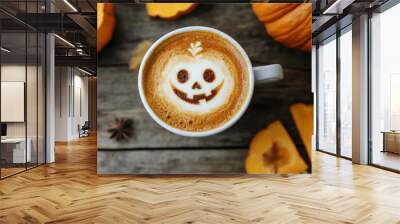 Cup of cappuccino is decorated with scary pumpkin face for halloween celebration on wooden background with pumpkins around Wall mural