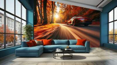 Luxurious sports car is speeding down a scenic forest road with colorful autumn foliage Wall mural