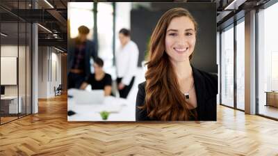 My team will get it done. Portrait of a businesswoman standing in a boardroom meeting with colleagues in the background. Wall mural