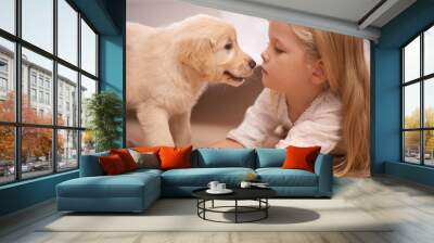 The best friend you can get. An adorable little girl with her puppy at home. Wall mural