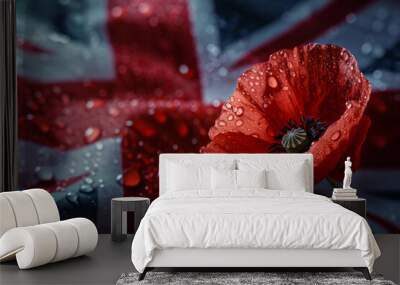 Poignant red poppy with dewdrops on its petals, symbolizing remembrance day, set against a blurred uk flag background Wall mural