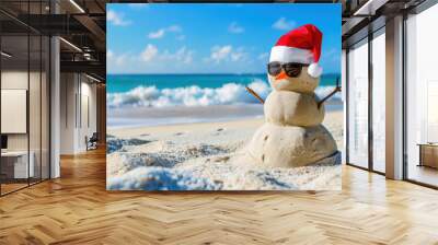 Sandy snowman wearing sunglasses and a santa hat is enjoying a sunny christmas on a tropical beach Wall mural