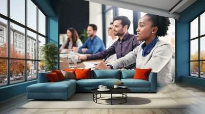 Listening intently. Cropped shot of a group of businesspeople sitting in on a presentation. Wall mural