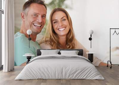 Love and laughter. Portrait of a happy couple smiling at you. Wall mural