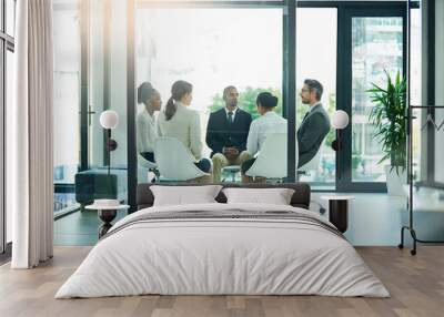 Paradigm shifts in the making. Shot of a diverse group of businesspeople having a meeting in the boardroom. Wall mural