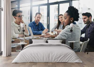 Sharing ideas and feedback. Cropped shot of a group of businesspeople meeting in the boardroom. Wall mural