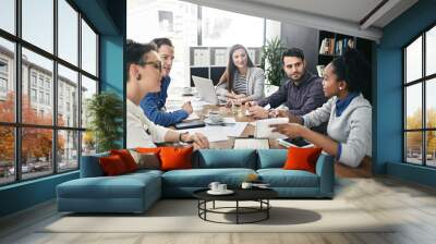 Utilizing the knowledge, experience and skills of everyone involved. Shot of a group of businesspeople having a meeting. Wall mural