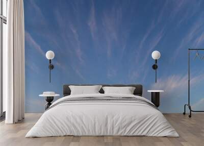 Streaky white clouds on blue sky. Wall mural