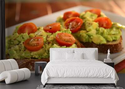 Avocado toast topped with cherry tomatoes and cracked pepper Wall mural