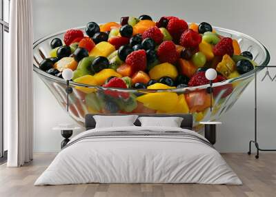 Brightly colored fruit salad in a glass bowl Wall mural