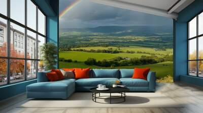 Magical rainbow arching over green countryside Wall mural