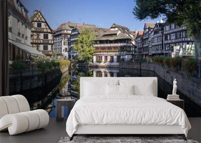 Strasbourg, France - August 28th 2024 : View of the Tanner's Quarter with half-timbered buildings and the Ill river and reflections on the water. Wall mural