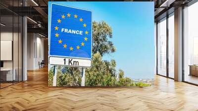 Road sign on the border of France as part of an European Union member state Wall mural