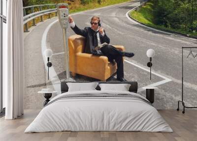 businessman sitting on armchair in the middle of the road Wall mural