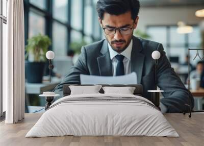 Serious Businessman Reading Documents in Modern Office Environment Wall mural