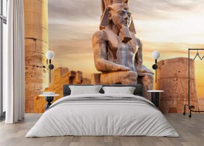 Seated statue of Ramesses II by the Luxor Temple entrance, sunset scenery, Egypt Wall mural