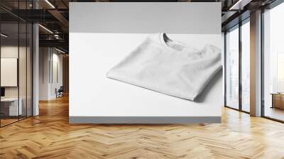 Basic folded white Tshirt on grey table. Mock up for branding t-shirt. Monochrome trend.  Wall mural