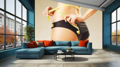 slimming woman in panties with yellow measure Wall mural