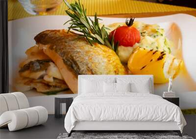 White fish fillet with puree served with lemon and rosemary in a white plate, restaurant setting Wall mural