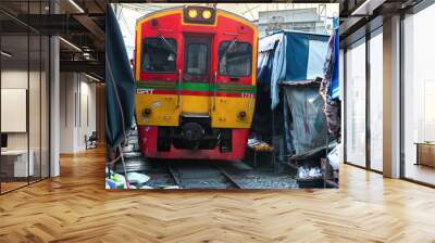 02.02.2020 Thailand, Samut Songkhrami, Mae Klong railway market also called Siang Tai. Tourists walk along the train tracks and take photos and selfies of the approaching train.  Wall mural