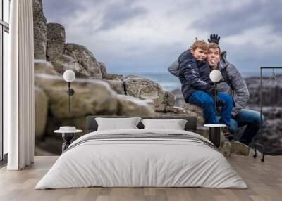 Father and son at Giants causeway in autumn, Northern Ireland Wall mural