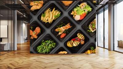 Collection of black plastic take away boxes with healthy food. Set of containers with everyday meals - meat, vegetables and law fat snacks on black background Wall mural