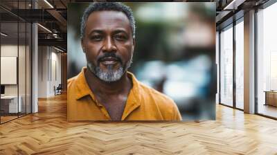 Middle-aged Nigerian man with casual attire and a confident look. Wall mural