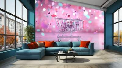 Miniature shopping cart with confetti on pink background. Online shopping concept. Cyber monday sale banner. E-commerce and digital retail marketing for social media with copy space Wall mural