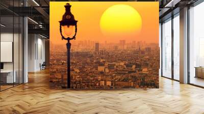 Paris rooftops. City view at magic orange sunset. Giant bright sun disk on  beautiful sky. Vintage street lamp is on the soft blur foreground  Wall mural