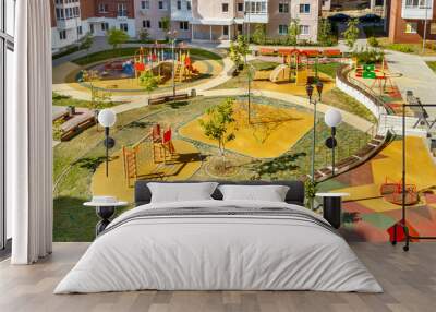 top view of empty new modern children playground in courtyard of high-rise residential buildings in  Wall mural