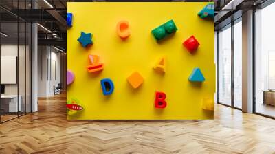 Top view on children s toys on a yellow background. Children's toys on the table. concept for advertising toys for children. Copy space children's toy. Wall mural