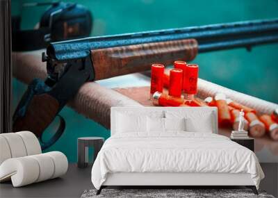 Hunting shotgun with bullets cartridges drop rain. smoke Wall mural