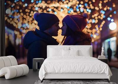 Photo of two amorous pair in love at x-mas midnight illuminated streets standing opposite going to kiss wearing warm jackets outside Wall mural