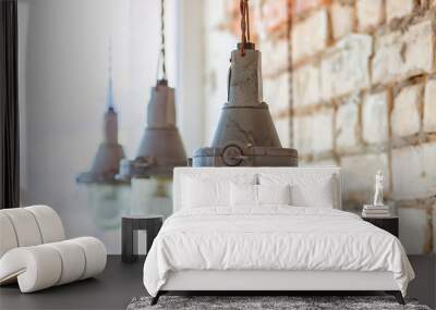 Hanging vintage lamps in a loft style on the brick wall background. Wall mural