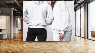 Basic clothing brand mockup. Design template for hoodie and casual sportswear. A woman and man wearing hoodies with no logo. Horizontal sweatshirt mock-up Wall mural