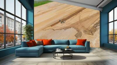 Construction vehicles leveling dirt area Wall mural