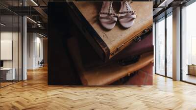 in the room on the floor old suitcases are stacked, on top are women's shoes Wall mural