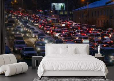 Car traffic jams due to snowfall in the evening. Wall mural