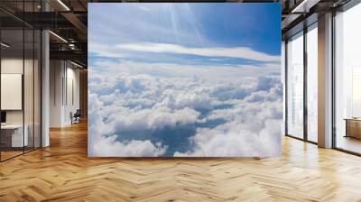 View from the porthole of an airplane. A beautiful view of the white clouds from a height of 10,000 meters. Wall mural