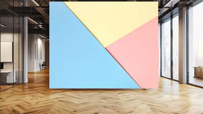 Abstract asymmetrical geometric watercolor paper background in three colors soft pastel pink, blue and yellow trend colors. Wall mural