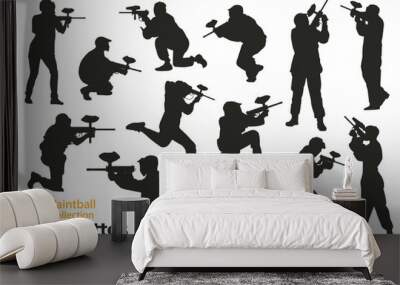 Collection of paintball player silhouettes. Different poses of people playing with weapons. Wall mural