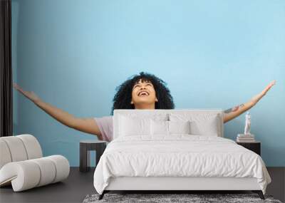 Black woman, happy and open arms in studio for marketing mockup, happiness celebration and excited in blue background. African girl, smile and surprised hands gesture or surprise growth development Wall mural