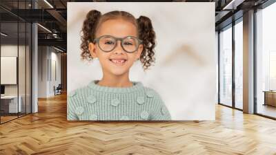 Kid, girl or face vision glasses in optometrist, ophthalmologist or eye exam clinic for eyes healthcare, wellness or support. Portrait, smile or happy child and optometry prescription or fashion lens Wall mural