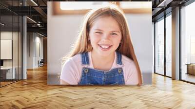 Portrait, happy and girl relax at a window in a living room, cheerful an excited while sitting alone in her home. Face, child and preteen female with positive mindset relaxing with a cute smile Wall mural